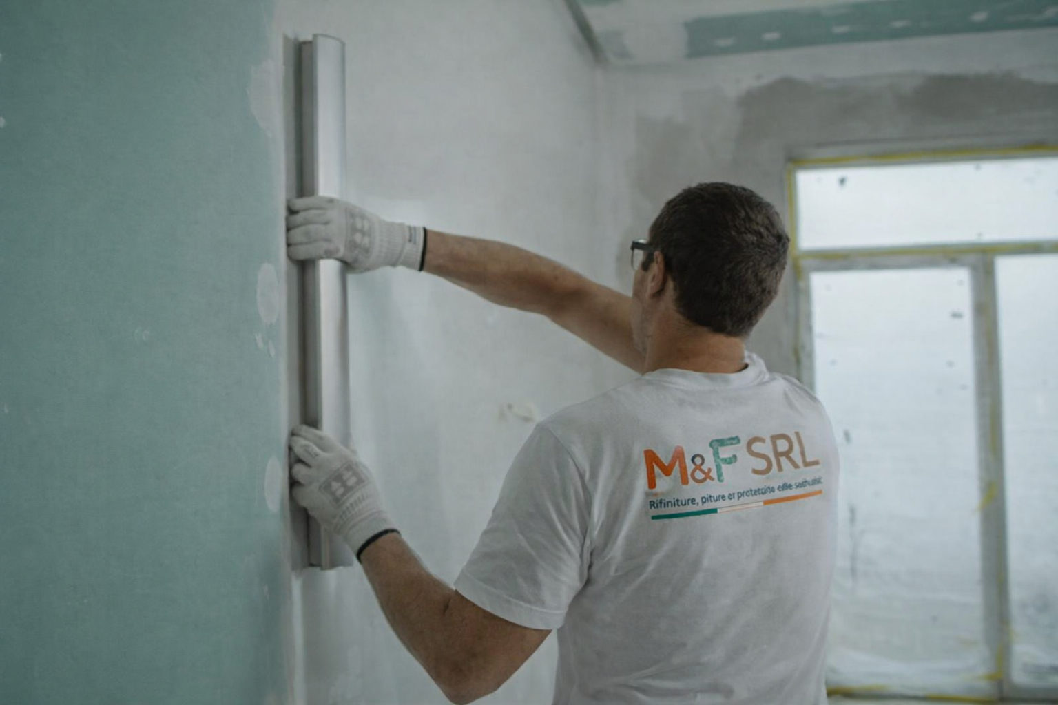 Worker Smoothing Plastered Wall In Progress
